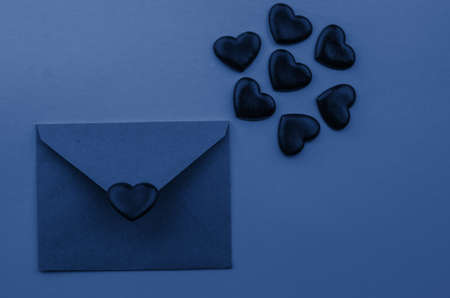 Valentine's day.Envelope with red hearts on Brown wooden background.の写真素材