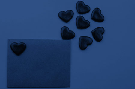 Valentine's day.Envelope with red hearts on Brown wooden background.の写真素材