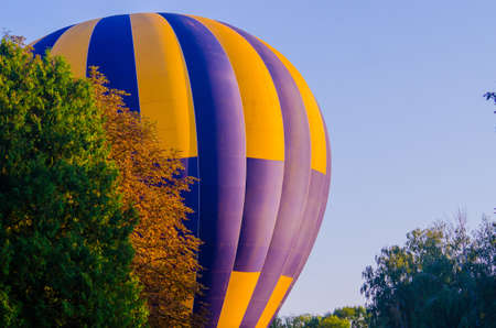 hot air balloon is flying at sunriseの写真素材