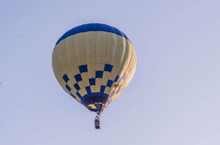 hot air balloon is flying at sunriseの写真素材
