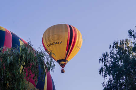 hot air balloon is flying at sunriseの写真素材