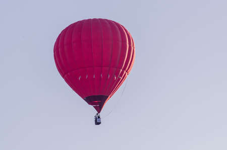 hot air balloon is flying at sunriseの写真素材