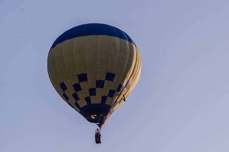 hot air balloon is flying at sunriseの写真素材