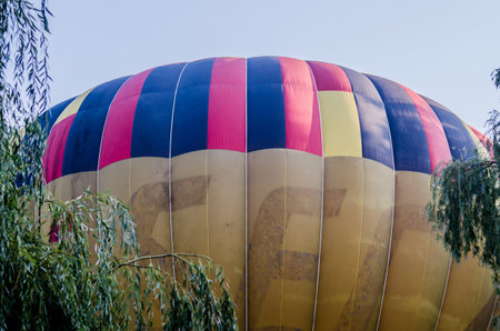 hot air balloon is flying at sunrise