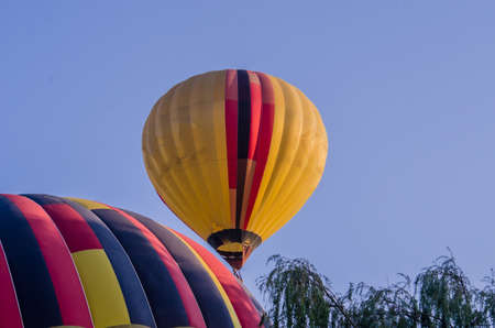 hot air balloon is flying at sunriseの写真素材