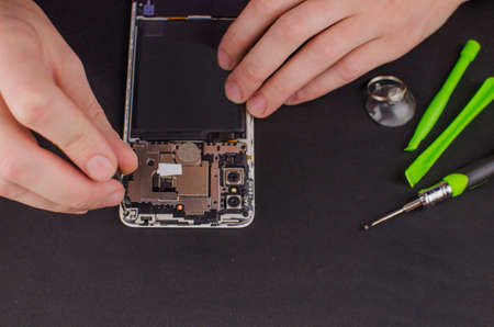 smartphone repair on black background.の写真素材