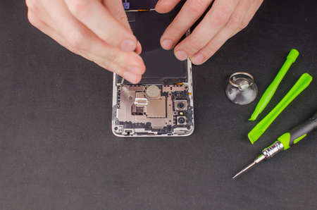 smartphone repair on black background.の写真素材