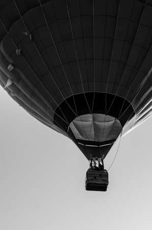 hot air balloon is flying at sunriseの写真素材