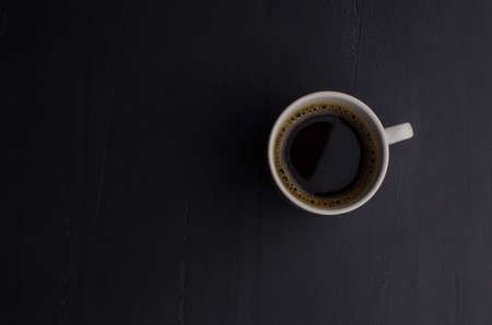 Black closeup on dark backdrop. Coffee espresso on dark background. Space texture.の写真素材