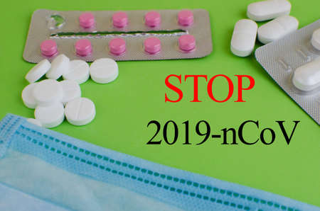 Text phrase Coronavirus on a green background with medicines and protective masks. Novel coronavirus 2019-nCoV, MERS-Cov middle East respiratory syndrome coronavirus.の写真素材