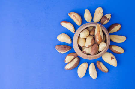 Brazilian nut on a blue background. The concept of a healthy food. Close up backgroundの写真素材