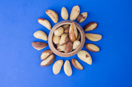 Brazilian nut on a blue background. The concept of a healthy food. Close up backgroundの写真素材