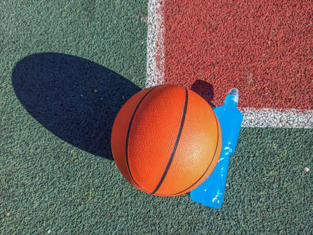 Healthy lifestyle. Basketball and water on the court.の写真素材