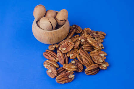 Pekan nut close-up on a classic blue background. Copy space for textの写真素材
