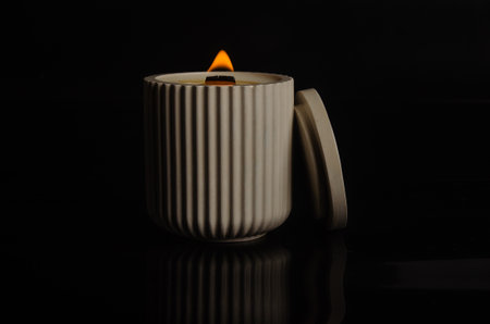 a candle in a flowerpot on a black background. high quality photoの写真素材