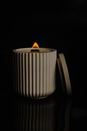 a candle in a flowerpot on a black background. high quality photoの写真素材