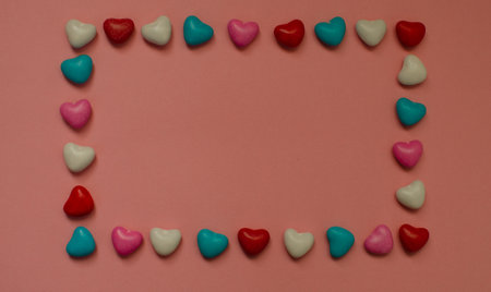 Colorful heart made of candies on a pink background. Valentines Day greeting card. copyspaceの写真素材