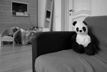 plush panda sitting on a sofaの写真素材