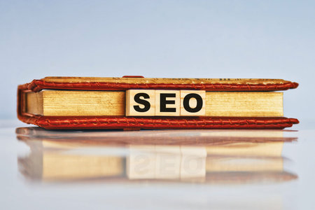 SEO abbreviation, search engine optimization ranking concept. Wooden cubes with notepad and...