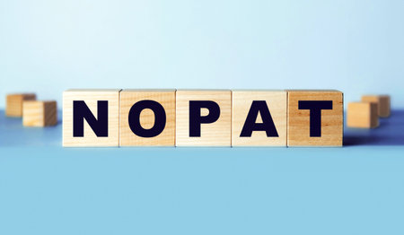 Net Operating Profit After Tax is an abbreviation made of wooden cubes. Finance concept.