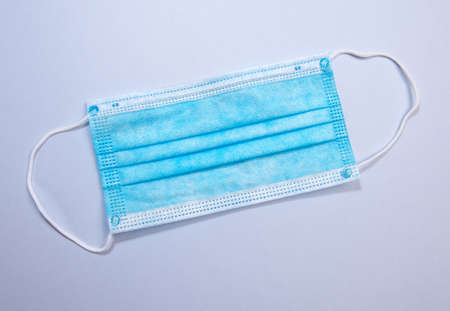 Three-layer surgical mask for covering mouth and nose from bacteria. Protection concept.の写真素材