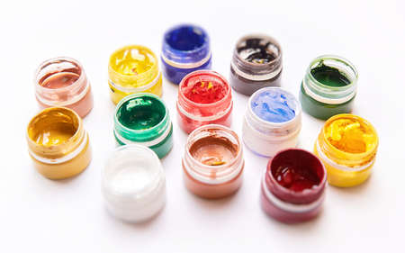 Colorful bright jars of gouache on a white background.の写真素材