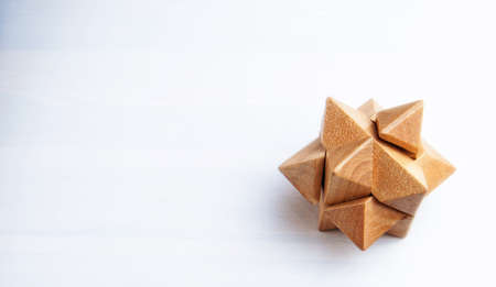 Wooden puzzle in the form of a star on a white background.の写真素材