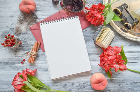 White paper mock up on rustic wood background with natural style decorations. Berries and fruits border. Blank template, art letters, background space for text, vintage mock up.の写真素材