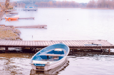 Boat near wooden pier, nature autumn cardの写真素材