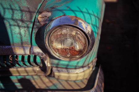 Headlight of vintage car. Blue old time automobile with shiny headlights