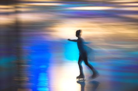 skating girls in motion in covered skating rinkの写真素材