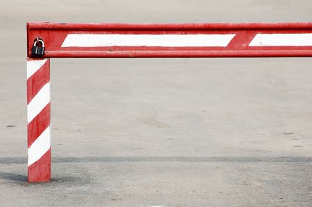 old red white stripy locked barrierの写真素材