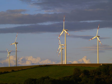 agricultural landscape with wind energy plants in germany, evening light