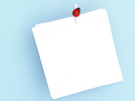 blank white note pad over bright blue backgroundの写真素材