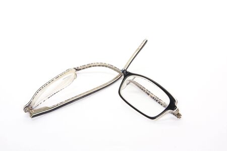 broken eyeglasses on whiteの写真素材