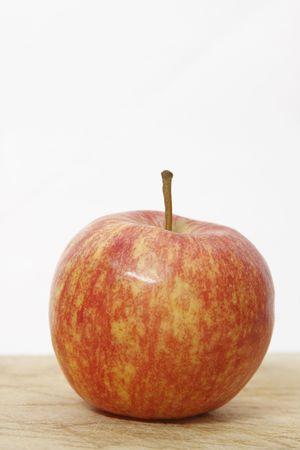 red and yellow apple on woodの写真素材