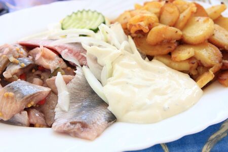 pickled herring and fried potatoesの写真素材