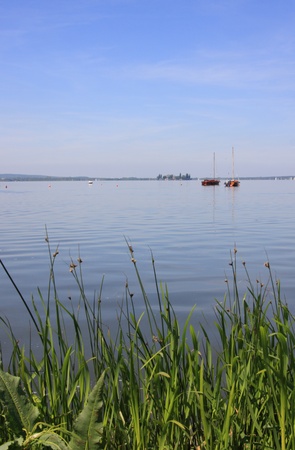 boats on lake steinhuder meerwith reed in the front, lower saxony, germanyの写真素材