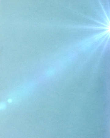 A grungy gradient blue background paper with the sun shining 	の写真素材