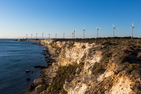 wind turbines generating clean power with lighthouseの写真素材
