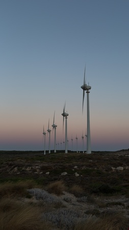 wind turbines generating clean power at blue hoursの写真素材