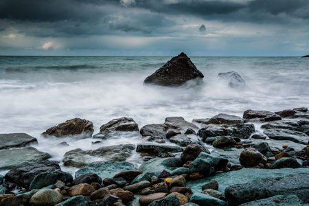 storm waves crash against the rocks