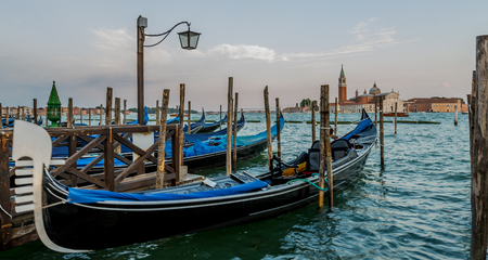 A view of famous Traditional Venice gondolas parking on grand canal and Piazza San Marco Squareの写真素材