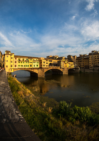 A view of Ponte Vecchio bridge on sunset time and Arno river in Florence. Tuscany, Italyの写真素材