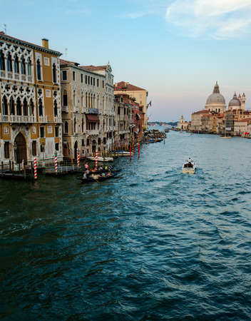 Buildings and traditional Venice gondolas riding on canal in Venice Italy at sunny summer dayの写真素材