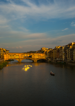A view of Ponte Vecchio bridge on sunset time and Arno river in Florence. Tuscany, Italyの写真素材