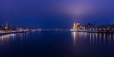 A view of Hungarian Parliament building and Danube river at night.の写真素材