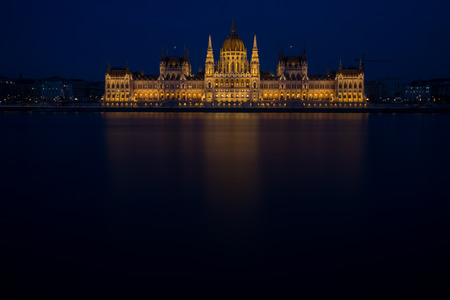 A view of Hungarian Parliament building and Danube river at night.の写真素材