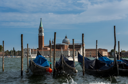 A view of famous Traditional Venice gondolas parking on grand canalの写真素材