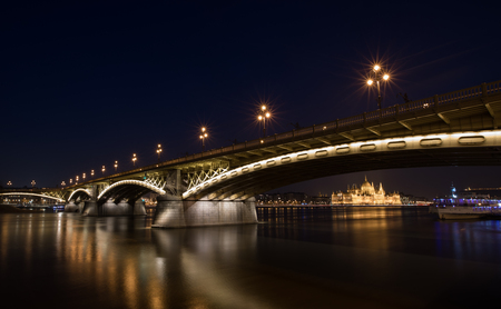 A night view of Margaret bridge over the Danube and famous historical Parliament building at dusk in Budapest Hungaryの写真素材